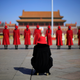 Women working at the NPC session stand outside the Great Hall of the People on Tuesday.